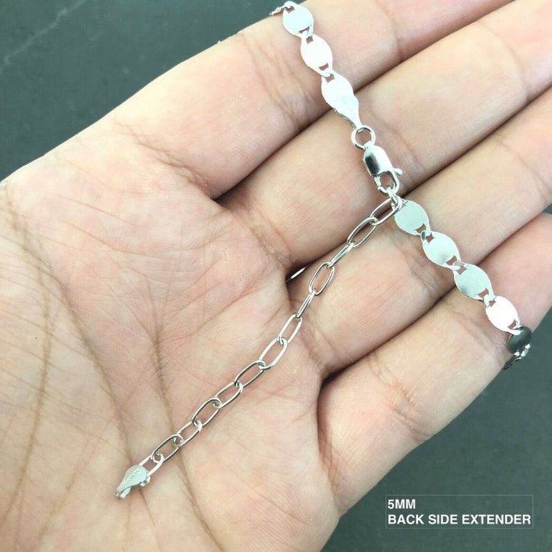 May include: A silver chain bracelet with a 5mm back side extender. The chain is made of oval links.