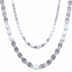 May include: Two silver chains with oval links. The chains are layered on top of each other.