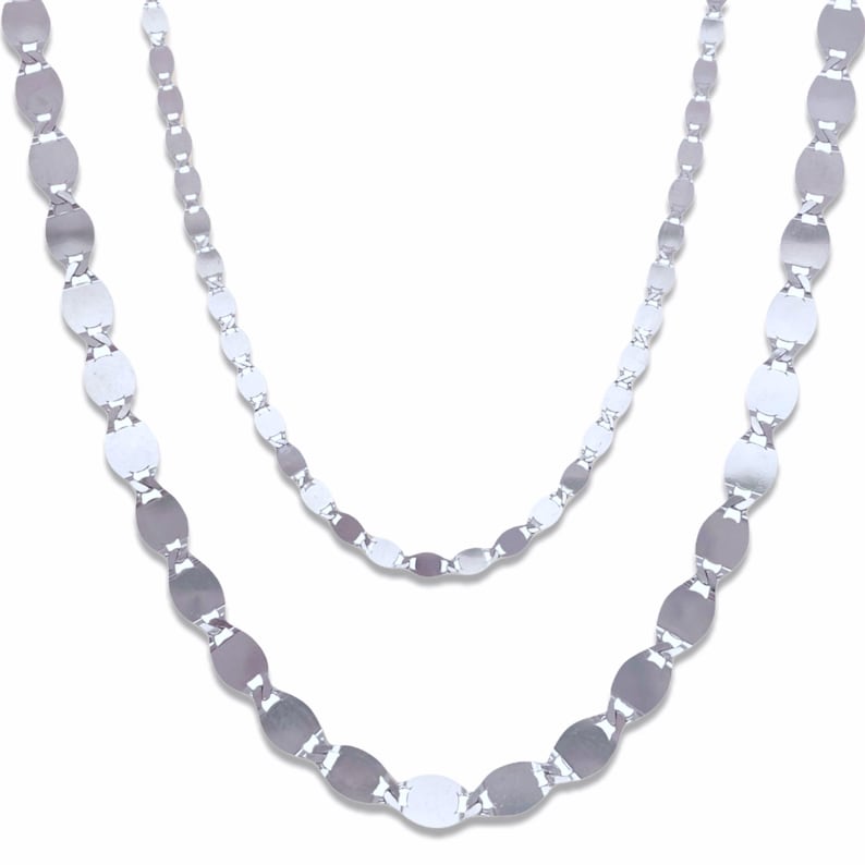 May include: Two silver chains with oval links. The chains are layered on top of each other.
