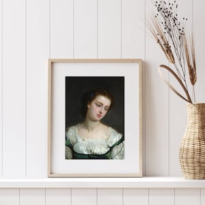 May include: A framed portrait of a woman with dark hair and a white lace collar. She is wearing a green dress and has a serious expression on her face.