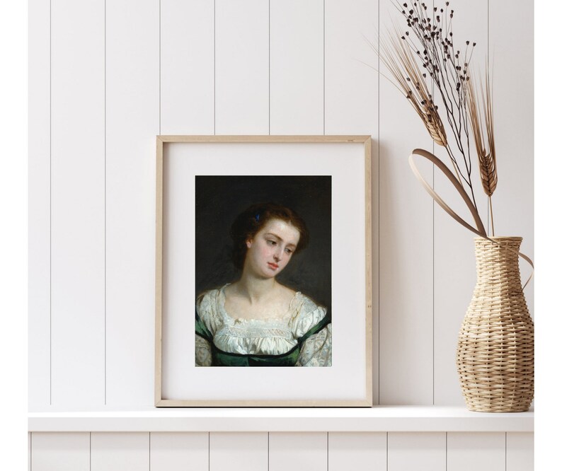 May include: A framed portrait of a woman with dark hair and a white lace collar. She is wearing a green dress and has a serious expression on her face.