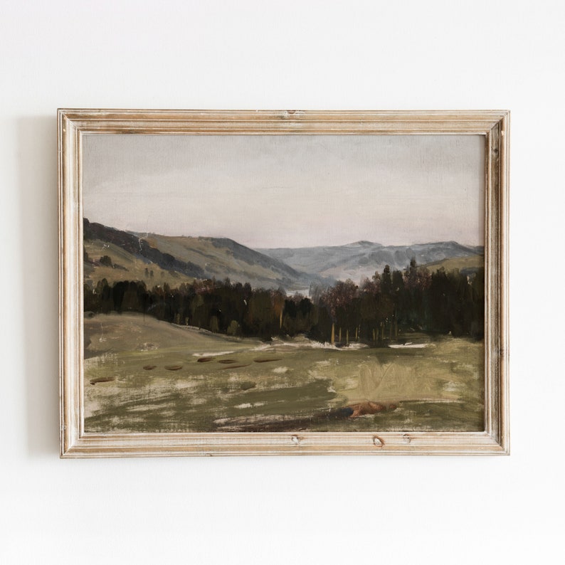 May include: A framed painting of a landscape with rolling hills, a forest, and a river in the distance. The painting is done in muted tones of green, brown, and gray.
