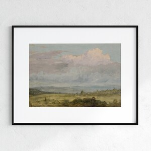 May include: A framed painting depicting a landscape with a large, fluffy, pink-hued cloud in the sky above a field of green grass and trees.