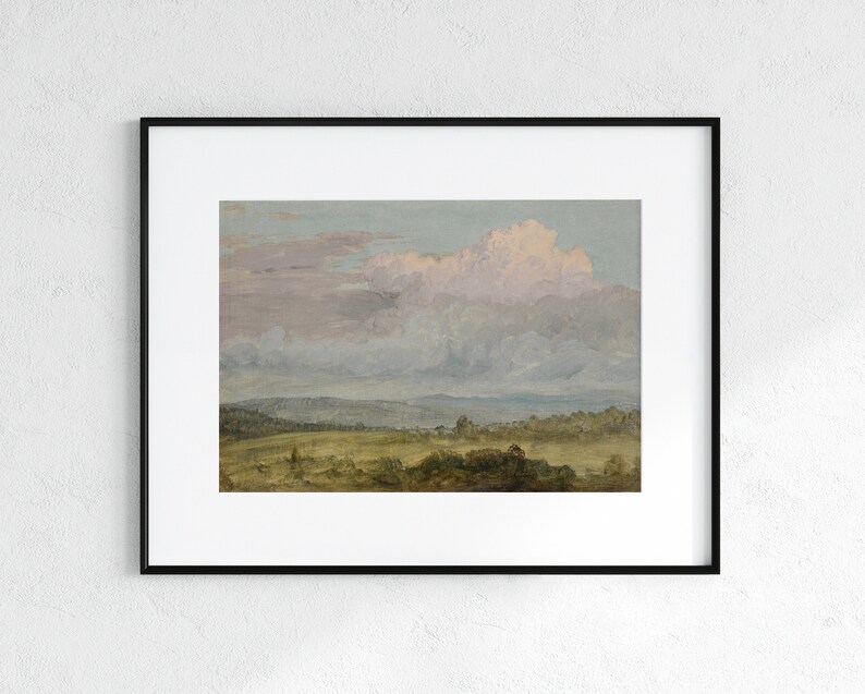 May include: A framed painting depicting a landscape with a large, fluffy, pink-hued cloud in the sky above a field of green grass and trees.