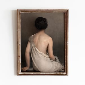May include: A framed painting of a woman sitting with her back to the viewer, wearing a white draped garment. The painting is set against a neutral background.