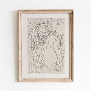 May include: A black and white abstract line drawing in a light wood frame. The drawing is of a figure with a flowing, organic shape. The artist's signature "ew19" is visible in the bottom left corner.