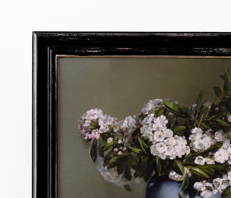 May include: A framed painting of a bouquet of white flowers in a blue vase. The flowers are arranged in a loose, natural style, and the vase is simple and elegant.