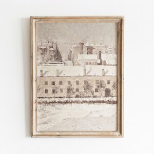 May include: A framed painting depicting a snowy cityscape with buildings in the background and a row of houses in the foreground. The painting is done in muted tones of brown, white, and gray.