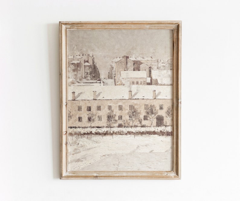 May include: A framed painting depicting a snowy cityscape with buildings in the background and a row of houses in the foreground. The painting is done in muted tones of brown, white, and gray.