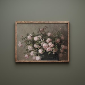 May include: A framed vintage-style print featuring a bouquet of pink roses in a dark vase. The artwork has a muted color palette with a distressed, aged appearance. The wooden frame adds a rustic touch.