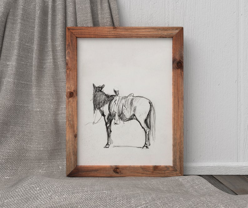 May include: A black and white pencil drawing of a horse with a saddle, framed in a rustic wooden frame.