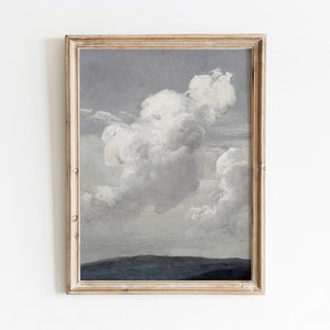 May include: A framed painting depicting a large, white cloud against a grey sky. The cloud is centrally positioned and surrounded by smaller clouds. The sky is a light grey colour and the horizon is a dark grey colour.