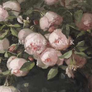 May include: An oil painting of a bouquet of pink roses with green leaves. The roses are in full bloom, with soft, delicate petals. The painting has a vintage aesthetic, with the text "MAPLE + OAK Vintage Creations" in the center.