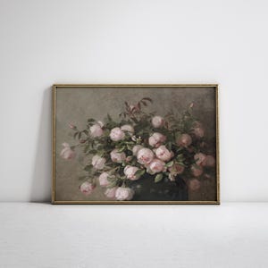 May include: A framed vintage floral print featuring a lush bouquet of pink roses. The roses are in full bloom, with soft, delicate petals. The artwork has a muted color palette and a gold frame.