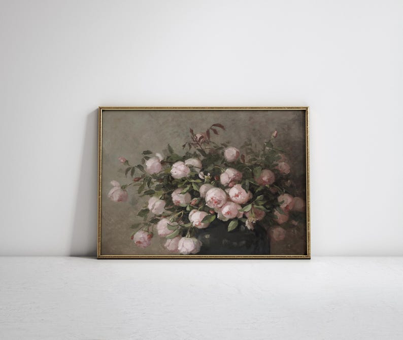 May include: A framed vintage floral print featuring a lush bouquet of pink roses. The roses are in full bloom, with soft, delicate petals. The artwork has a muted color palette and a gold frame.