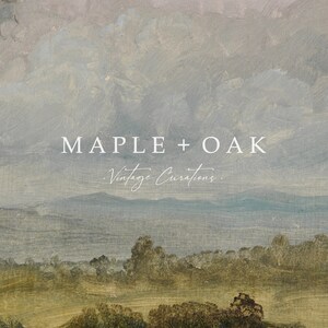 May include: A vintage-inspired landscape painting with a soft, muted color palette. The painting features a rolling green hill with a line of trees in the foreground, a body of water in the middle ground, and a mountain range in the background. The sky is a soft blue with white clouds. The text "MAPLE + OAK Vintage Curations." is superimposed on the painting.