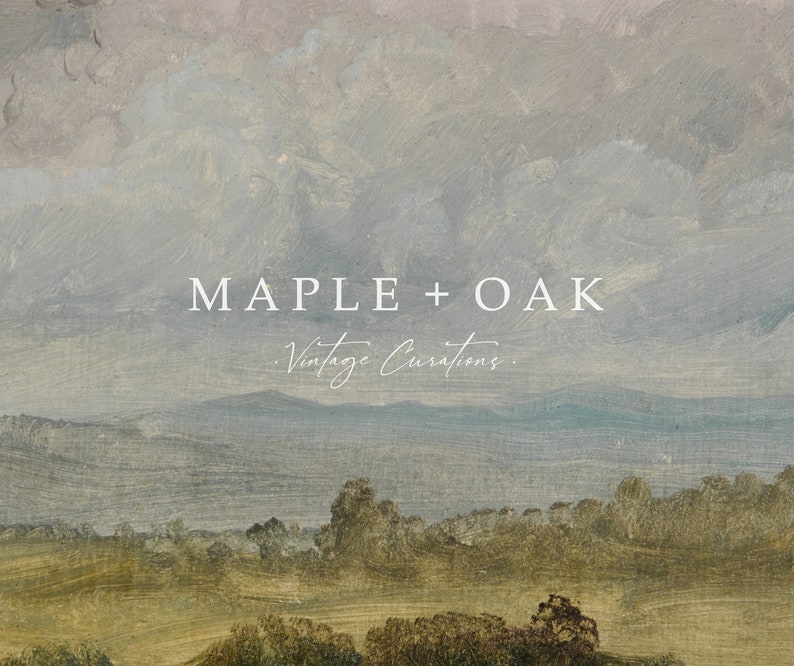 May include: A vintage-inspired landscape painting with a soft, muted color palette. The painting features a rolling green hill with a line of trees in the foreground, a body of water in the middle ground, and a mountain range in the background. The sky is a soft blue with white clouds. The text "MAPLE + OAK Vintage Curations." is superimposed on the painting.
