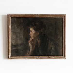 May include: An oil painting of a woman in profile, with her hand resting on her chin. The artwork is framed in a distressed, gold-toned wooden frame. The color palette is muted, with dark tones and a focus on the subject's face.
