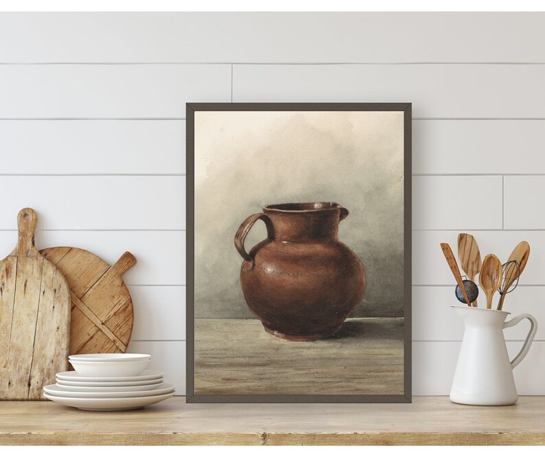 May include: A watercolor painting of a brown ceramic pitcher on a wooden table. The background is a light brown with a hint of blue.