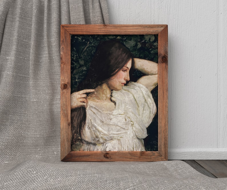 May include: A framed painting of a woman with long brown hair, wearing a white dress, with her head resting on her arm. The painting is set against a dark green background.