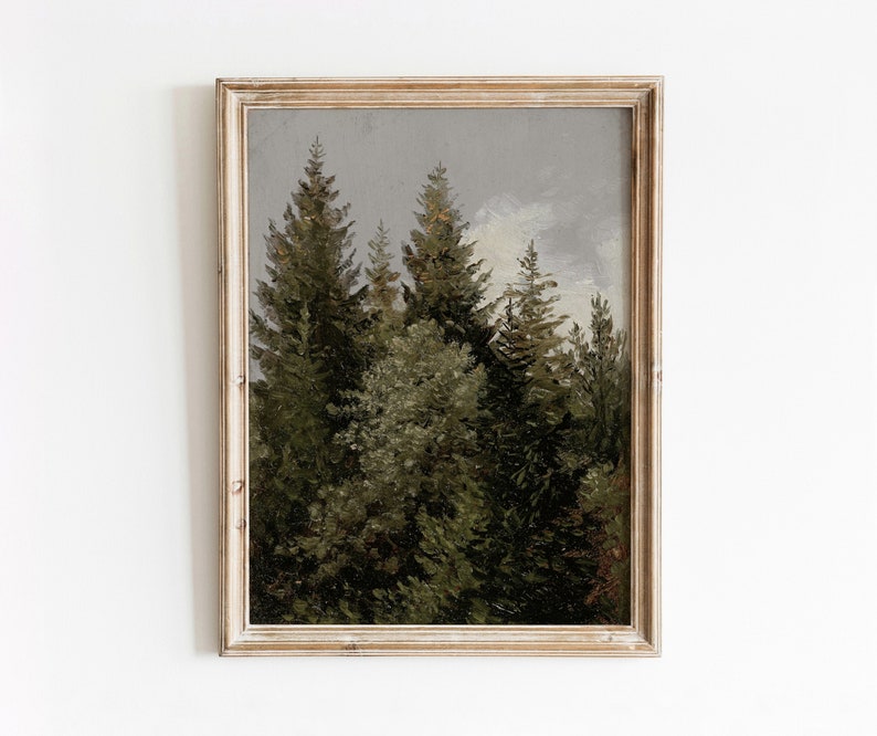Op de afbeelding: Een ingelijst schilderij van een boslandschap met hoge, donkergroene dennenbomen tegen een lichtgrijze lucht.