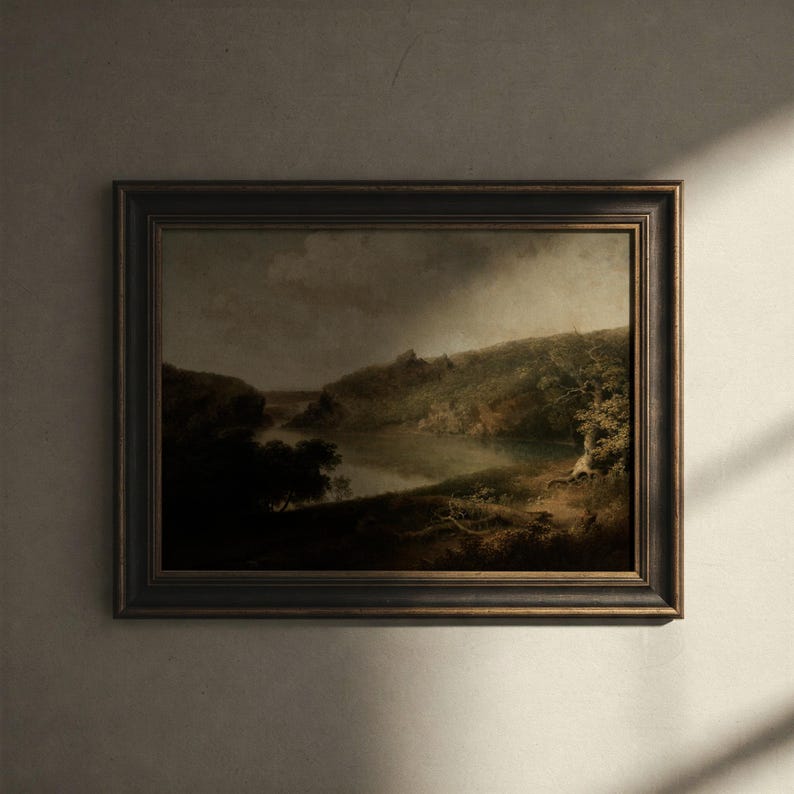 May include: A framed landscape painting depicting a river winding through a lush green valley. The painting is set against a cloudy sky and features a small cottage in the distance.