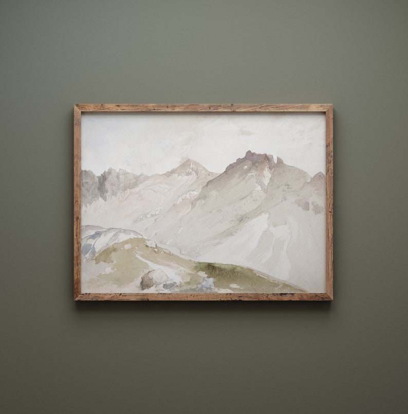 May include: A framed watercolor painting of a mountain range with a light gray and white color scheme. The mountains are depicted in a soft, abstract style, with a hint of green in the foreground.