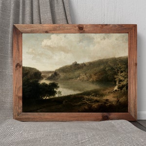 May include: A framed landscape painting depicting a river winding through a lush green forest. The sky is a soft blue with fluffy white clouds. The painting is in a rustic wooden frame.