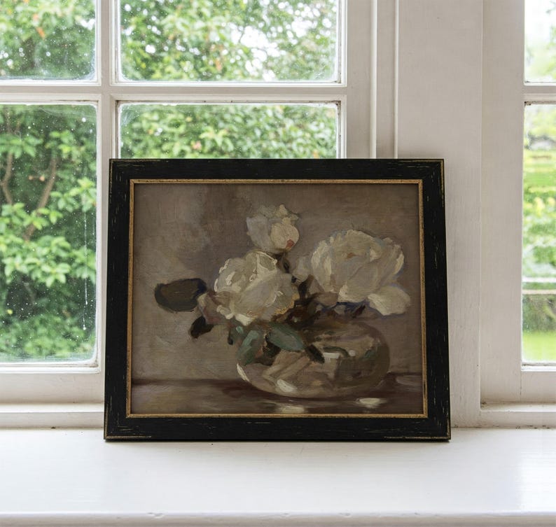 May include: A framed painting of white flowers in a clear glass vase. The flowers are arranged in a loose, natural style, and the painting is done in a realistic style.
