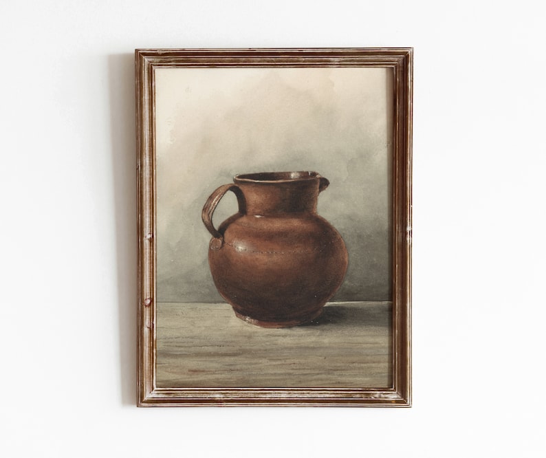 May include: A watercolor painting of a brown ceramic pitcher in a wooden frame.