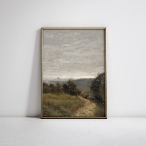 May include: A framed painting of a landscape with a dirt road leading through a forest. The sky is cloudy and gray, and the trees are a mix of green and brown.