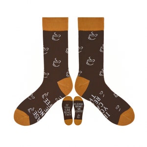 May include: Brown socks featuring a coffee cup design. The socks have brown bases, tan heels, toes, and cuffs. Text on the soles reads "If you can read this" and "Please bring me coffee."
