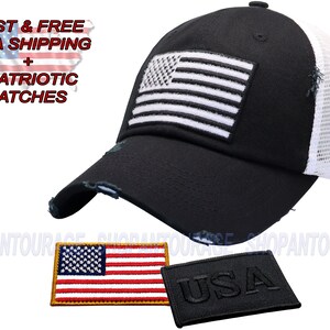 May include: Black and white distressed trucker hat with a white American flag on the front and a white mesh back panel. The hat has a black "USA" embroidered on the back. The hat comes with two patches: a red, white, and blue American flag patch and a black "USA" patch.