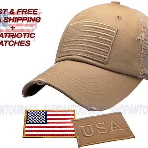 May include: A tan distressed baseball cap with a mesh back. The cap has a brown embroidered American flag on the front and the word "USA" on the back. The cap comes with two patches: a small American flag patch and a brown patch with the word "USA" on it.