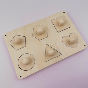 Puede incluir: Juguete de madera con seis formas diferentes: c&iacute;rculo, cuadrado, coraz&oacute;n, pent&aacute;gono, hex&aacute;gono y tri&aacute;ngulo. Cada forma tiene una perilla de madera en el centro.