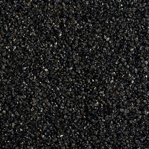 May include: Close-up of black gravel, a type of decorative aggregate used in landscaping and construction.