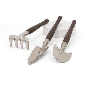 May include: A set of three small gardening tools: a rake, a trowel, and a curved blade. Each tool has a silver metal head and a dark brown wooden handle. The tools are arranged on a white surface.
