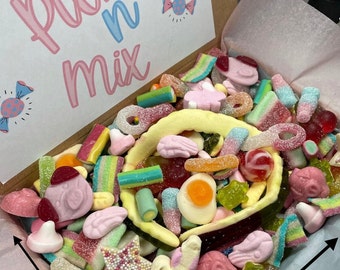 May include: A pink and blue box filled with a variety of colorful candies, including gummy bears, sour candies, and lollipops. The box is labeled "Pick n Mix" and measures 15.9 inches by 21.8 inches.