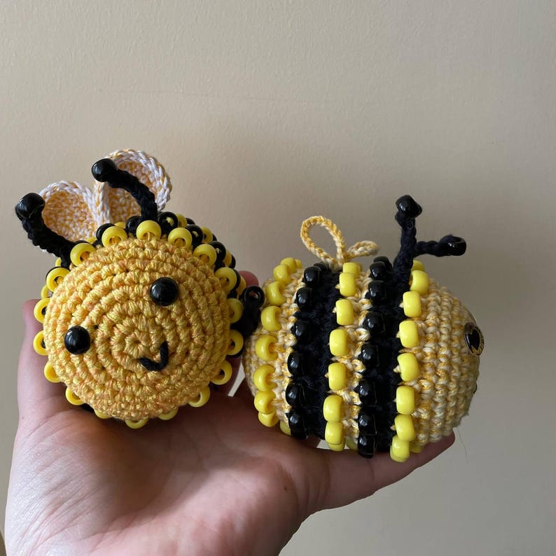 Child holding both crochet bees as fidget toys