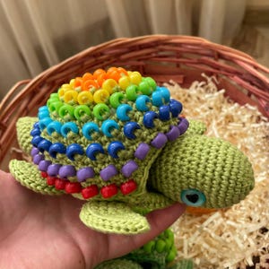 Rainbow shell beads teaching color recognition to toddler