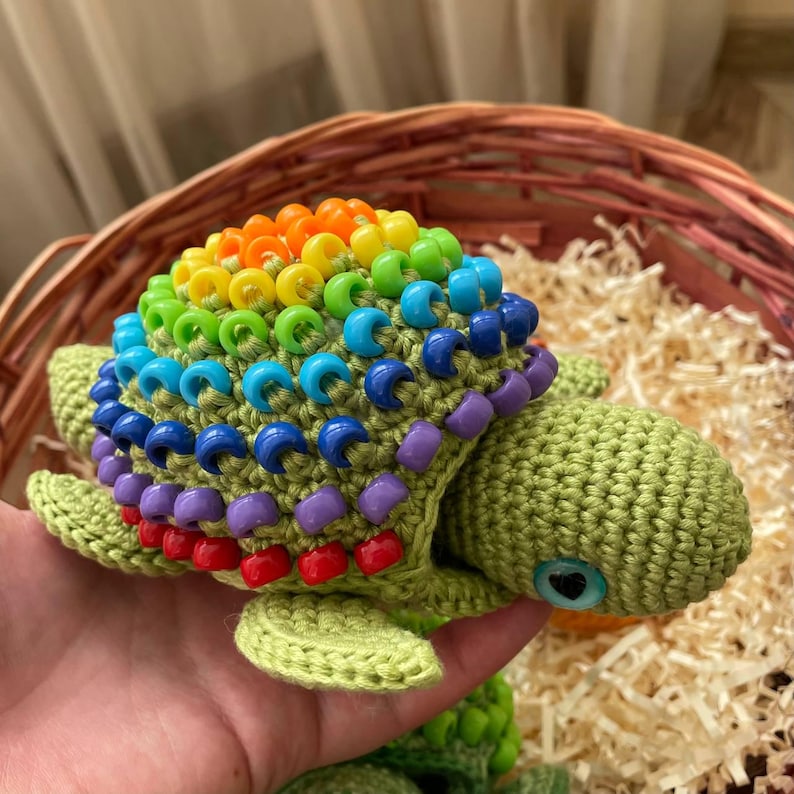 Rainbow shell beads teaching color recognition to toddler