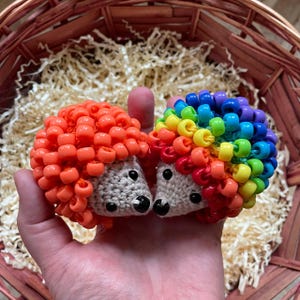 May include: A white ceramic mug with a black handle and the text "But First, Coffee" in a black, handwritten-style font. The mug is on a white surface.