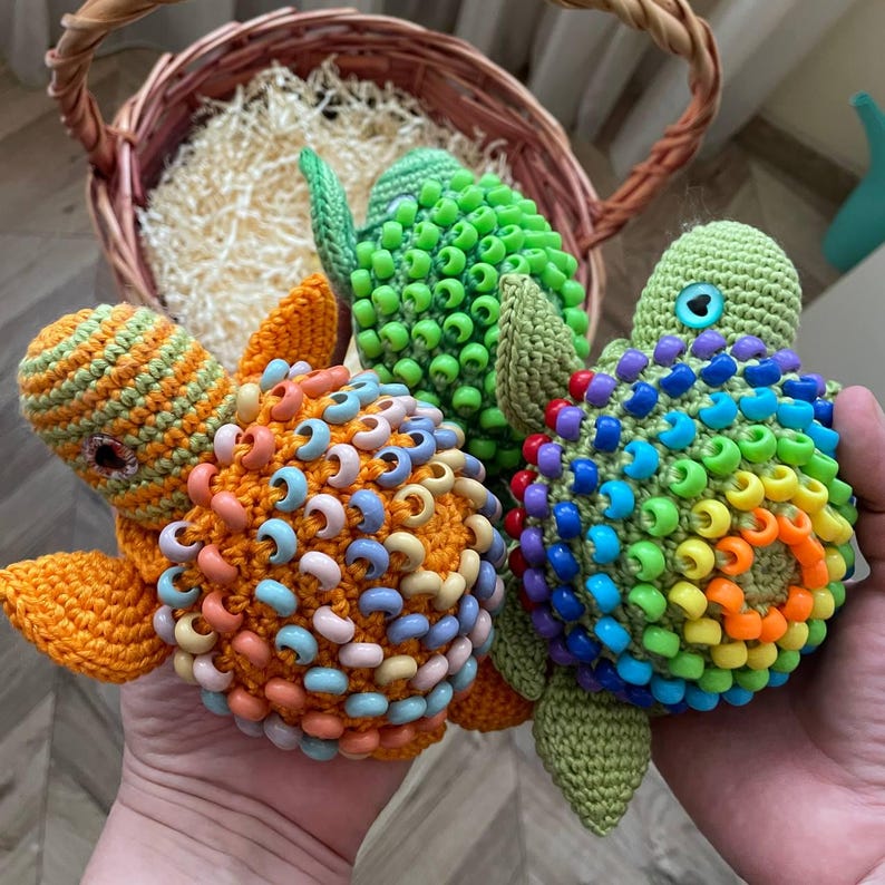 Three crochet fidget turtles: rainbow, orange, green for sensory play