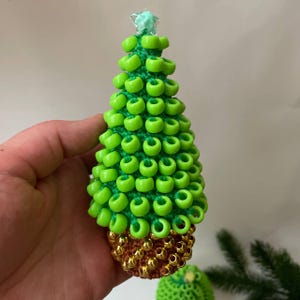 The Christmas tree sits on a wooden desk, shown as a fidget toy for focus
