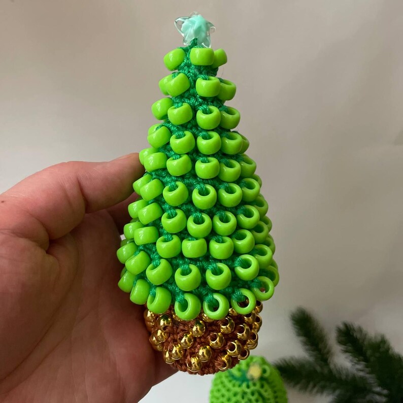 The Christmas tree sits on a wooden desk, shown as a fidget toy for focus