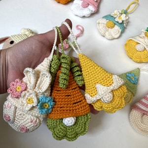 Get ready for an adorable addition to your Easter decor with this Easter gnomes set of 12 crochet pattern! These charming gnomes, including flower gnomes, Easter bunny gnome, carrot gnome, and lamb gnome, will bring a whimsical touch to your home.