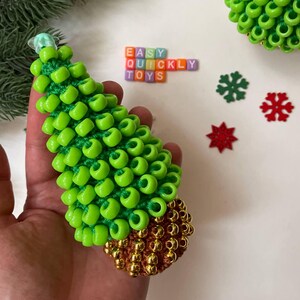 A child's hand gently touches the textured surface of the sensory tree