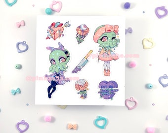 May include: A set of seven stickers featuring a green and pink cartoon character with tentacles, a heart with an arrow through it, a rose with an eye, a knife, a heart with the text "Best Friend", a brain with frosting, and a rose with an eye.