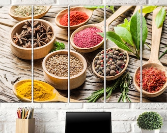 May include: A collection of spices and herbs in wooden bowls and spoons. The image features star anise, coriander, peppercorns, saffron, and turmeric. Green herbs and spices are arranged on a rustic wooden surface, creating a vibrant and colorful display.