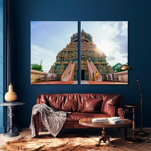 May include: A colorful Hindu temple with a tall, tiered structure and intricate carvings. The temple is decorated with vibrant colors, including blue, green, yellow, and red. The temple is set against a bright blue sky with a few clouds.